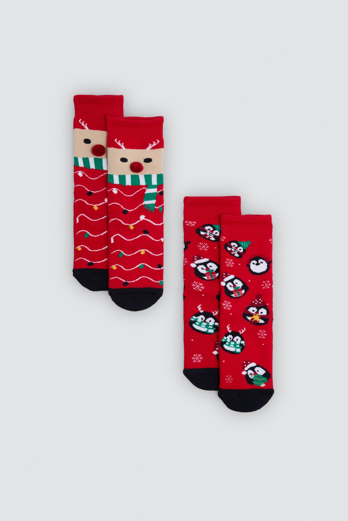 Pack de 2 meias infantis de Natal com renas e pinguins