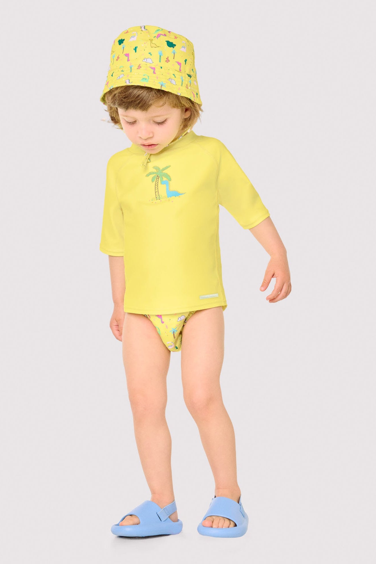 Camiseta de banho infantil com estampa de dinossauro e palmeira